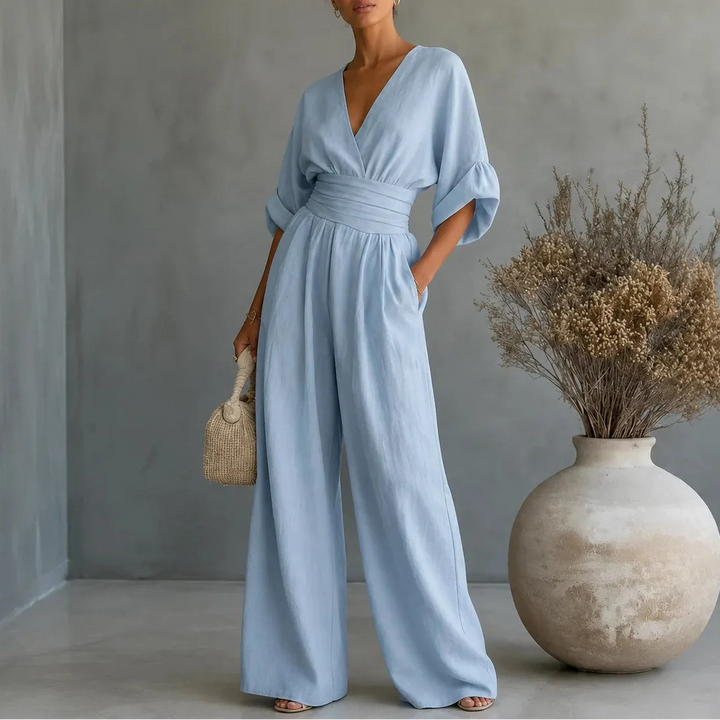 Soléra – Wide Leg V Neck Jumpsuit with Pleated Waist Sash